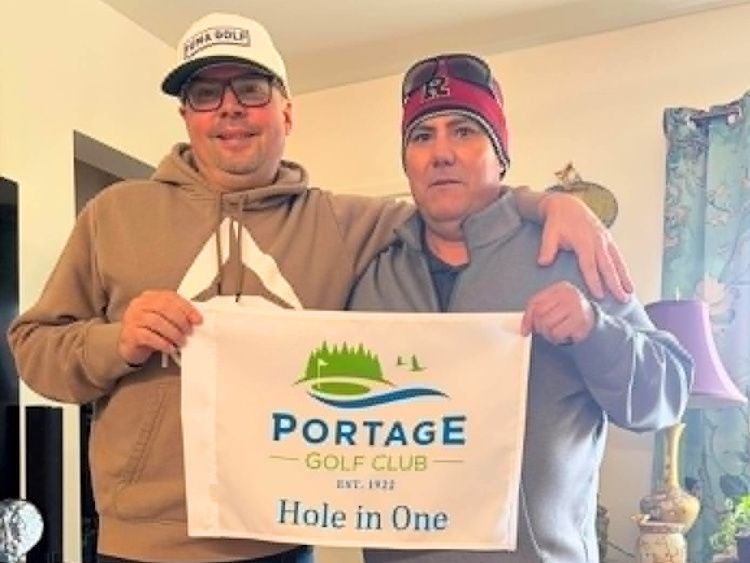 Rob Dupont (left) and friend Rick Brown celebrate away from the course after Dupont’s hole-in-one at the Portage Golf Club Tuesday. Brown says the moment had extra meaning for their family, noting his son also previously recorded a hole-in-one on the same hole.